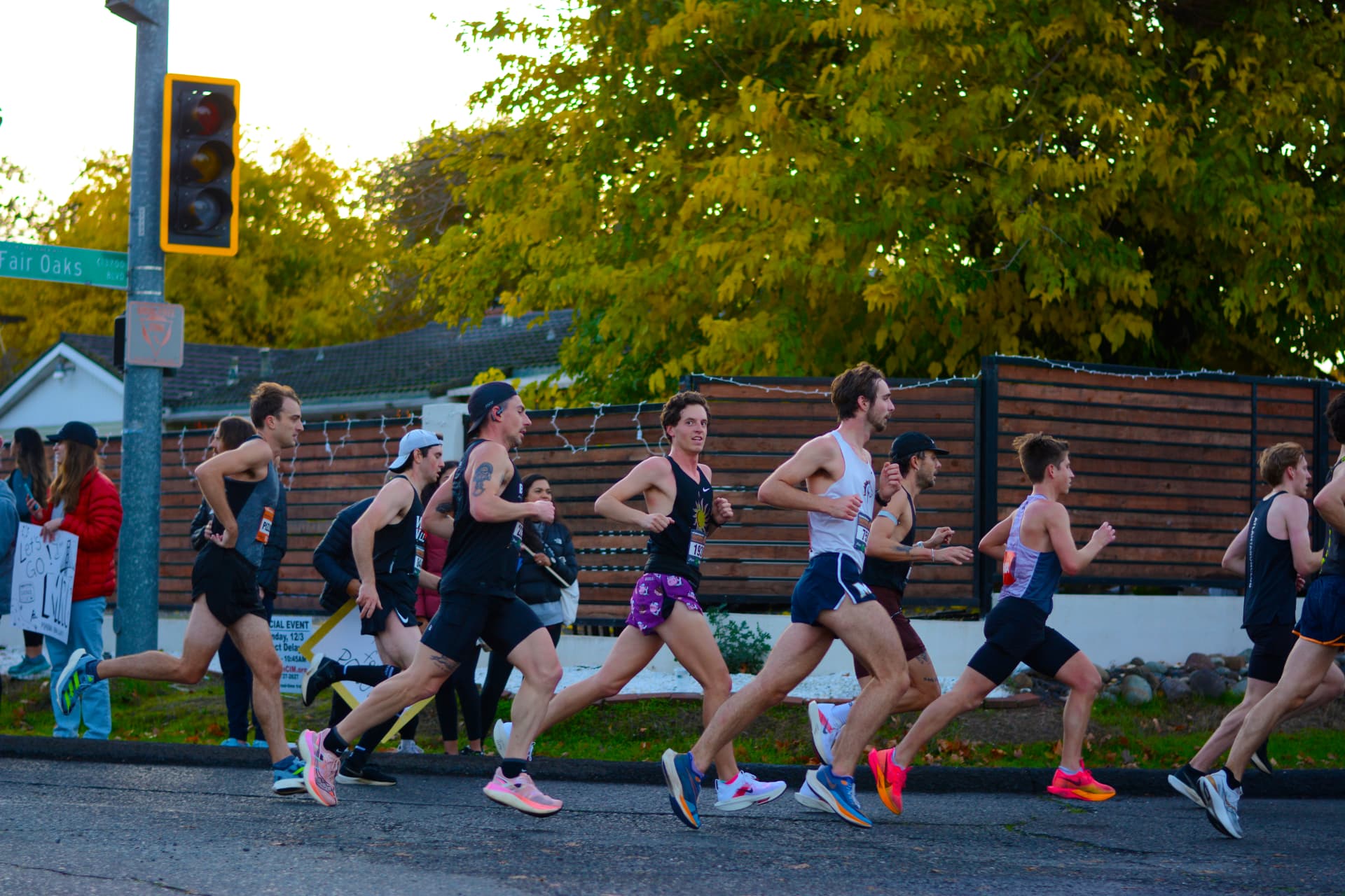 A runner locked on the camera as the pack rolls down Fair Oaks Boulevard