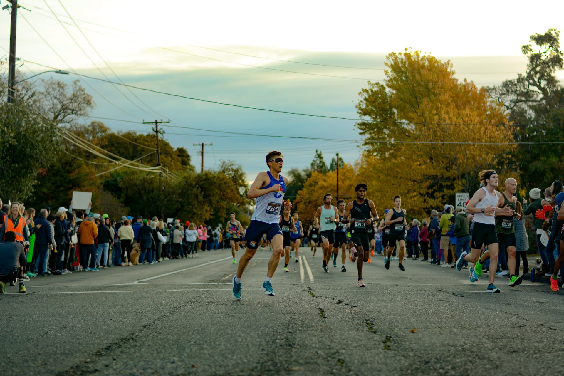 The lead pack rolling through an autumn neighborhood